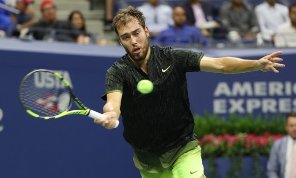 epa05514814 Jerzy Janowicz of Poland hits a return to Novak Djokovic of Serbia on the first day of the US Open Tennis Championship at the USTA National Tennis Center in Flushing Meadows, New York, USA ...