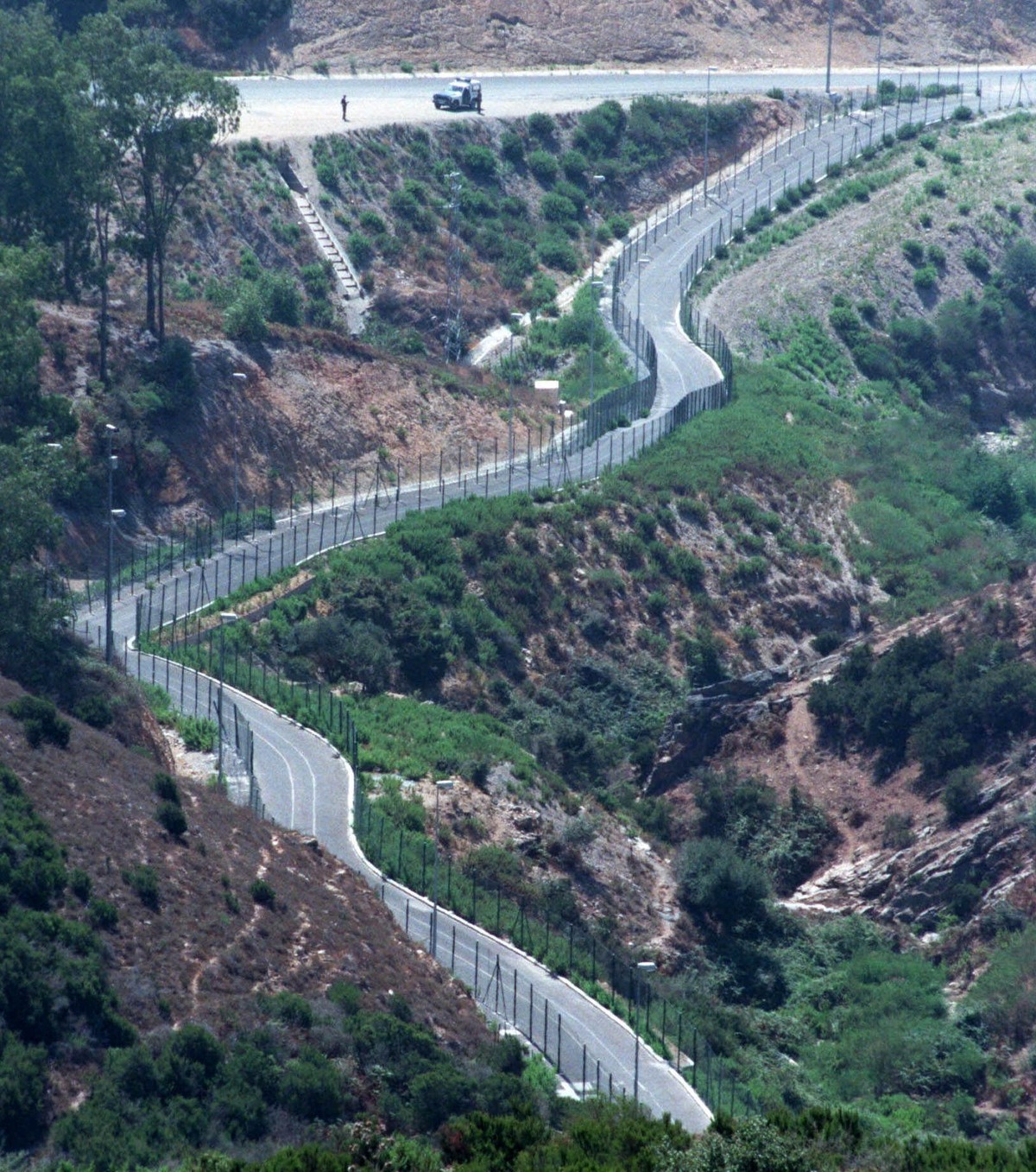 The newly-built fences on the border between the Spanish enclave of Ceuta and Morocco, snake through the countryside August 20, 1998. The new border "walls" will be completely finished by th ...
