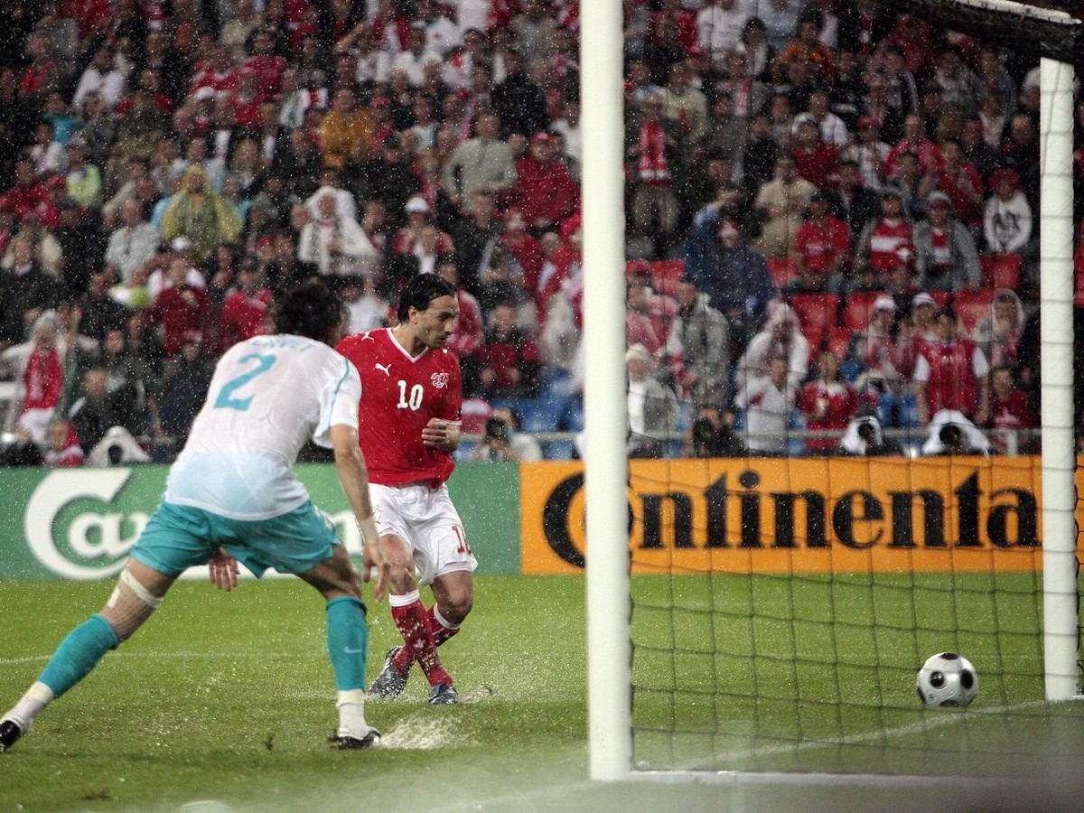 Switzerland's Hakan Yakin, right, scores the opening goal, watched by Turkey's Servet Cetin, left, during the second match of Group A between Switzerland and the Republic of Turkey during th ...