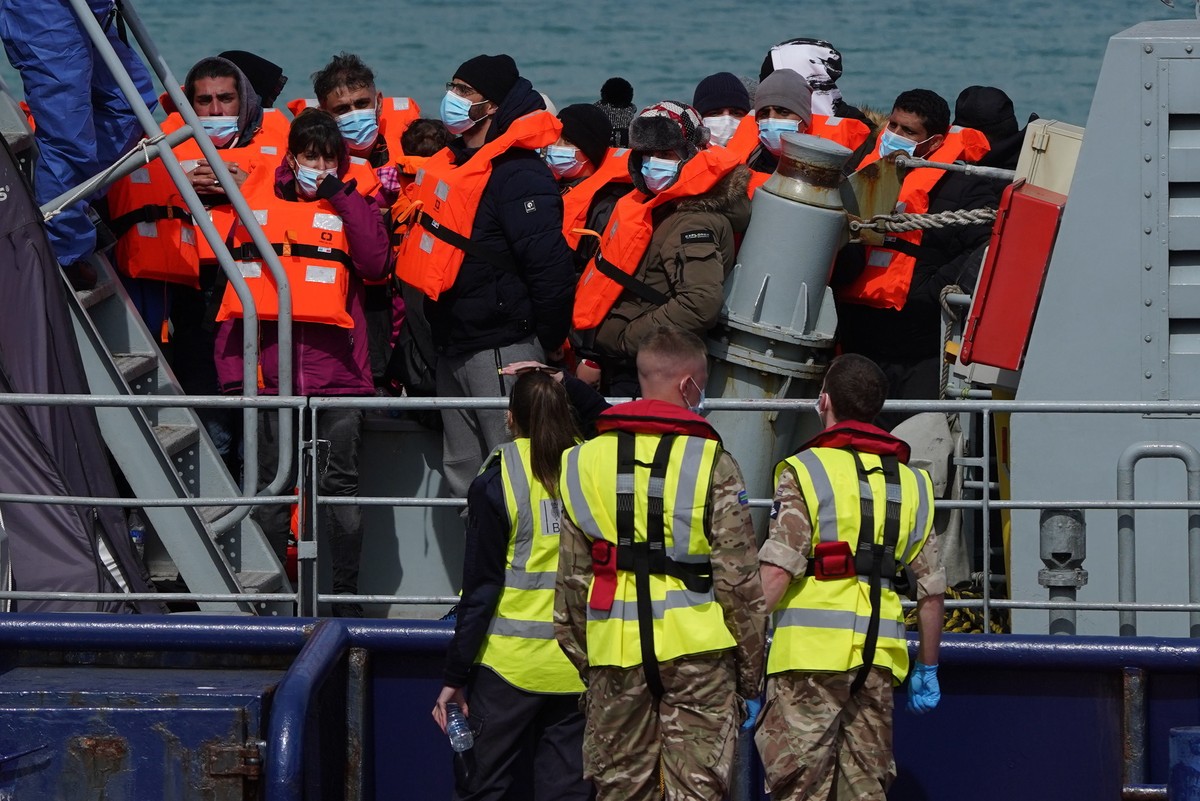 A group of people thought to be migrants are brought in to Dover, Kent, England, by the RNLI, following a small boat incident in the Channel, Thursday April 14, 2022. Britain's Conservative gover ...
