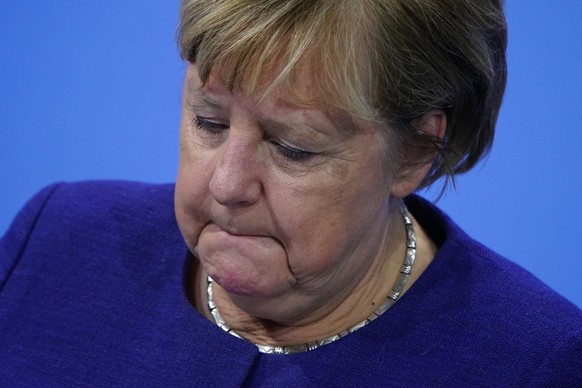 epa09589782 Acting German Chancellor Angela Merkel during a press conference after a meeting between German State Premiers and acting Chancellor on the occasion of the current coronavirus situation, a ...