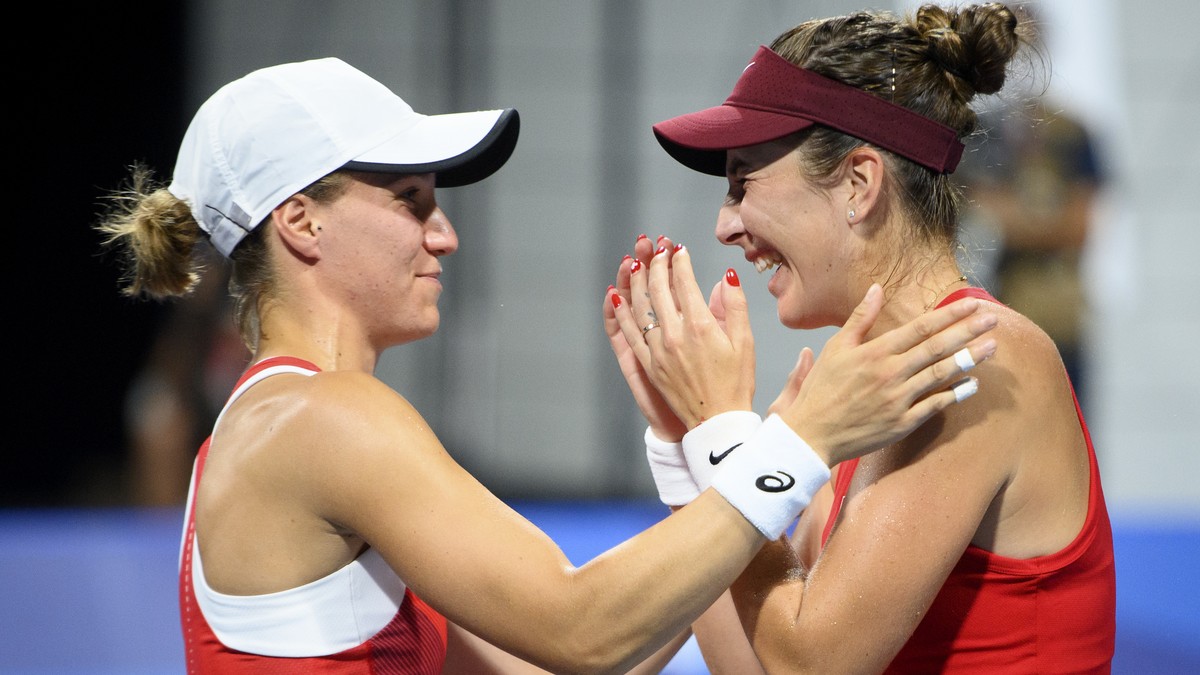 Belinda Bencic, right, and Viktorija Golubic, left, of Switzerland celebrate after winning against Laura Pigossi and Luisa Stefani of Brazil during the women's doubles tennis semifinal at the 202 ...