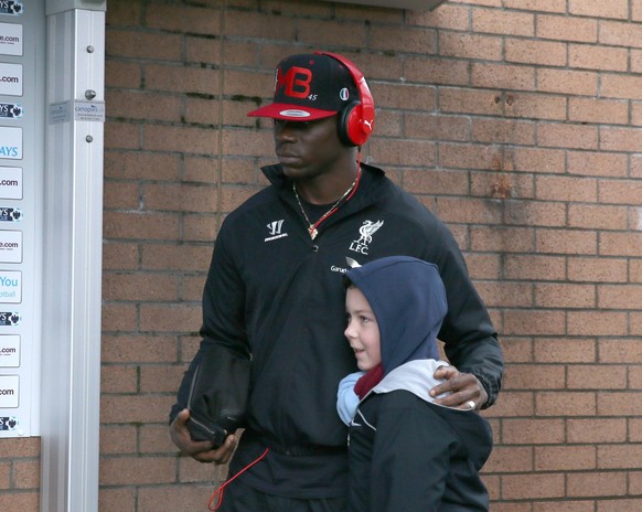Mario Balotelli of Liverpool poses with a young fan as he arrives before kick off - Barclays Premier League - Burnley vs Liverpool - Turf Moor Stadium - Burnley - England - 26th December 2014 - Pictur ...