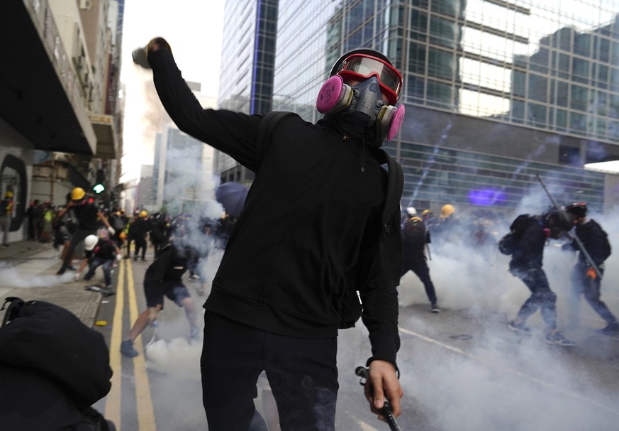 A protestor hurls an object as police and demonstrators clash during a protest in Hong Kong, Saturday, Aug. 24, 2019. Hong Kong protesters skirmished with police on Saturday as chaotic scenes returned ...