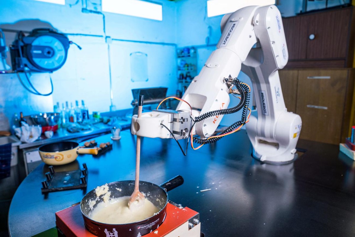 The world's first robot "Bouebot" is preparing a cheese fondue at the start-up workshop4.0 headquarter, in Sierre, Switzeland, on Monday, February 21, 2022. A robot, named Bouebot, has  ...