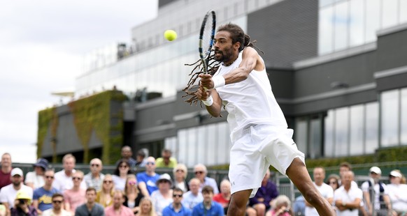 epa06063052 Dustin Brown of Germany in action against Joao Sousa of Portugal during their first round match for the Wimbledon Championships at the All England Lawn Tennis Club, in London, Britain, 03  ...