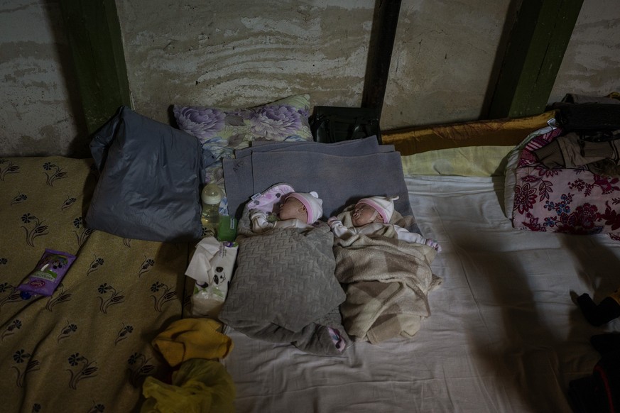 Newborn twin brothers sleep in a basement used as a bomb shelter at the Okhmadet children&#039;s hospital in central Kyiv, Ukraine, Monday, Feb. 28, 2022. (AP Photo/Emilio Morenatti)