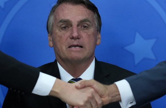 Brazil's President Jair Bolsonaro attends a ceremony at the Planalto presidential palace, in Brasilia, Brazil, Wednesday, Oct. 20, 2021. A Senate report recommended Wednesday pursuing crimes against h ...