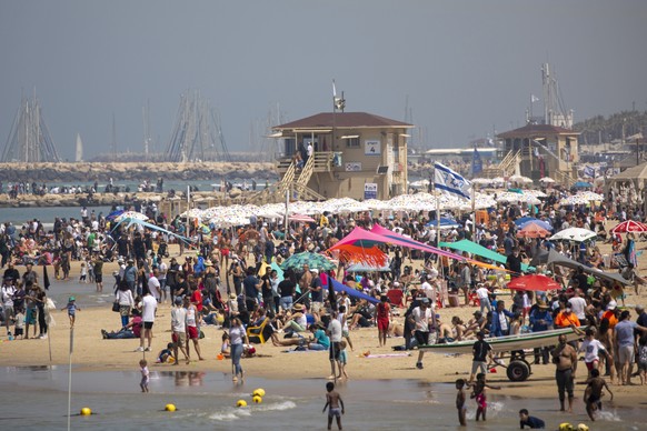 People flock to the beach after more than a year of coronavirus restrictions, during Independence Day celebrations, in Tel Aviv, Israel, Thursday, April 15, 2021. Israel is celebrating its annual Inde ...