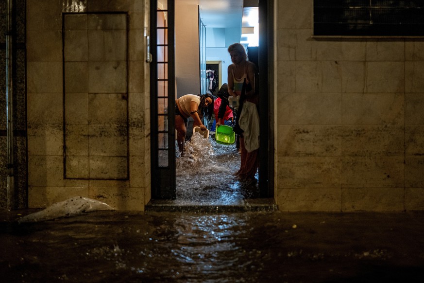Residents bail water out of their homes during heavy rain in L'Hospitalet de Llobregat, on the outskirts of Barcelona, Spain, Sunday, Oct. 4, 2026. (Lorena Sopena/Europa Press via AP)
Spain Weath ...