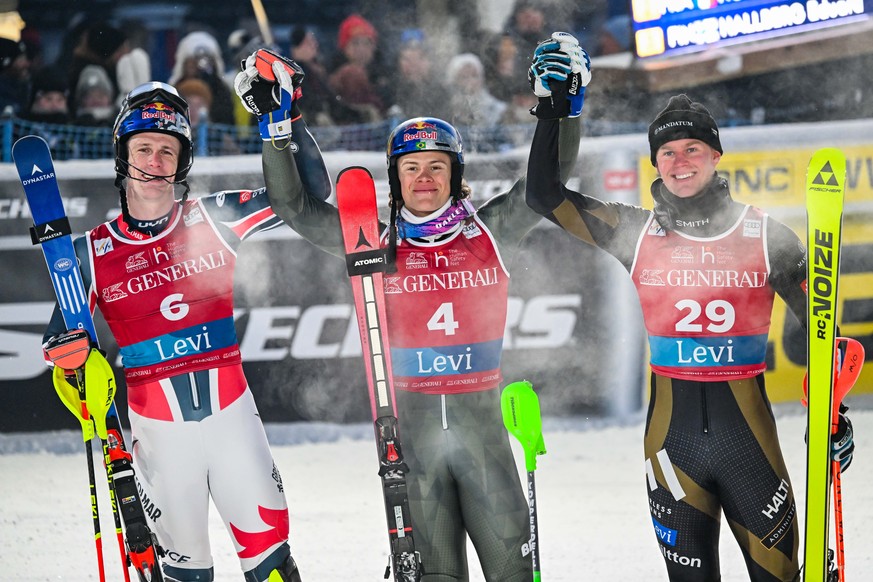 epa12529154 (L-R) Second placed Clement Noel of France, winner Lucas Pinheiro Braathen of Brazil and third placed Eduard Hallberg of Finland celebrate in the finish area after the men&#039;s slalom ra ...