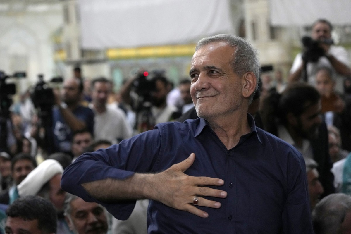 Iran's President-elect Masoud Pezeshkian greets his supporters in a meeting a day after the presidential election, at the shrine of the late revolutionary founder Ayatollah Khomeini, just outside ...