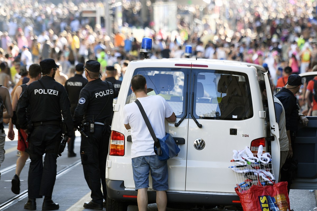Policemen and police vehicles seen on the occasion of the annual technoparade "Street Parade" in the city center of Zurich, Switzerland, Saturday, 13 August, 2016. Hundreds of thousands of r ...
