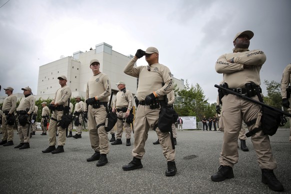 In this Oct. 19, 2017 photo, Troopers with the Florida Highway Patrol Quick Response Force line in front of the Phillips Center on the University of Florida campus in Gainesville, Fla., ahead of white ...