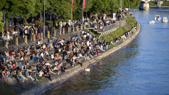 People enjoy the sun at the Rhein at the 69th Eurovision Song Contest in Basel, Switzerland, on Friday, May 16, 2025. (KEYSTONE/Peter Schneider)