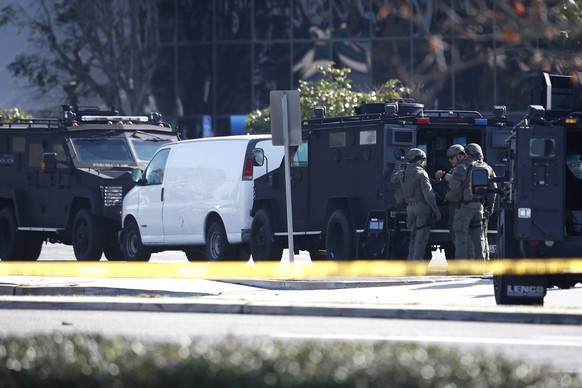 epa10423849 A white van which police reported was connected with a mass shooting at a dance studio in Monterey Park, California, sits trapped between two heavily armored police vehicles in Torrance, C ...