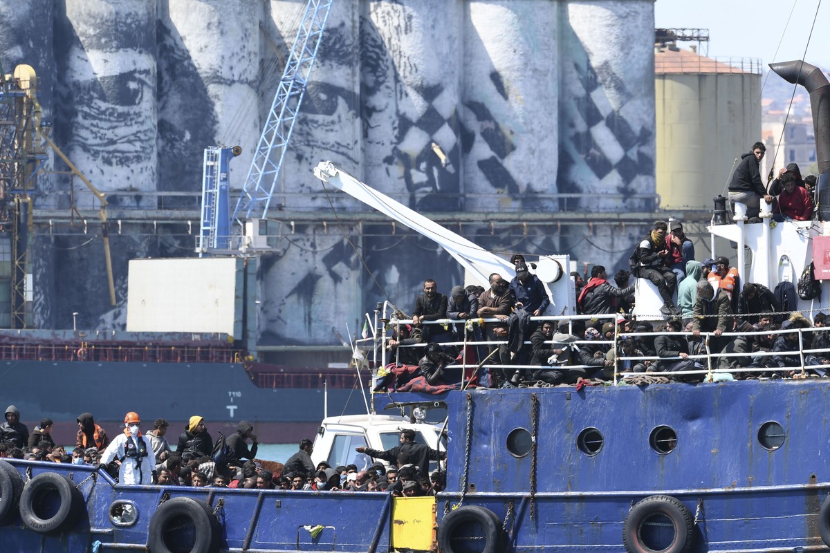A ship carrying some 700 migrants enters the Sicilian port of Catania, Wednesday, April 12, 2023. Italy's right-wing government has declared a state of emergency to help it cope with a surge in m ...