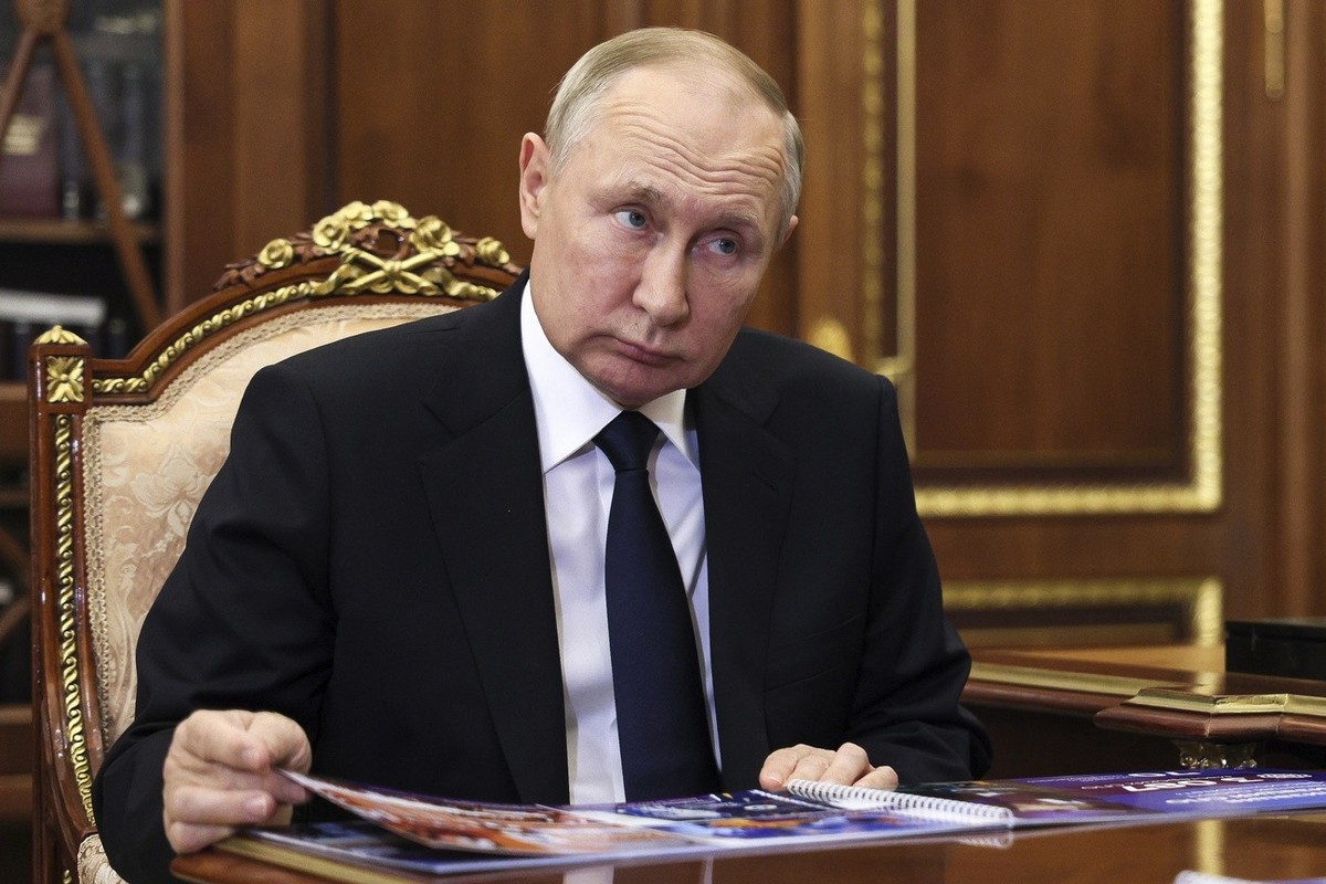 Russian President Vladimir Putin listens to Russian Education Minister Sergei Kravtsov during their meeting in Moscow, Russia, Monday, Jan. 9, 2023. (Mikhail Klimentyev, Sputnik, Kremlin Pool Photo vi ...
