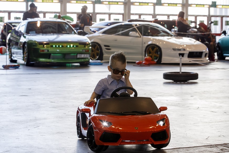 A kid drives around one of the tuned cars, during the Swiss Car Event, in Palexpo, in Geneva, Switzerland, Sunday, June 11, 2017. (KEYSTONE/Salvatore Di Nolfi)