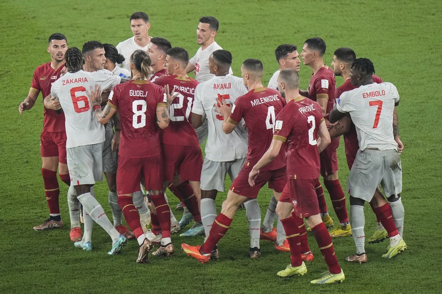 Switzerland's and Serbia's players, in red, argue during the World Cup group G soccer match between Serbia and Switzerland, at the Stadium 974 in Doha, Qatar, Friday, Dec. 2, 2022. (AP Photo/Luca Brun ...