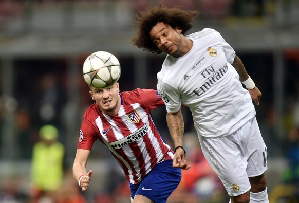epa05334606 Marcelo (R) of Real Madrid heads the ball in front of Saul Niguez of Atletico during the UEFA Champions League Final between Real Madrid and Atletico Madrid at the Giuseppe Meazza stadium  ...