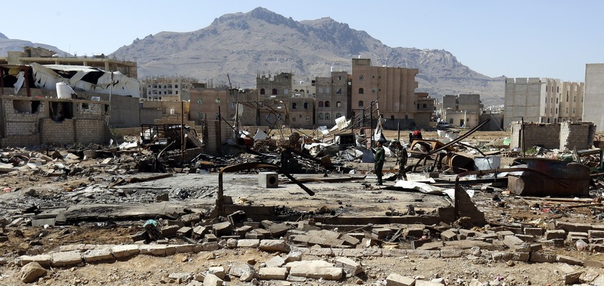 epa07494649 Yemeni soldiers inspect the site of an alleged Saudi-led airstrike hit a neighborhood two days earlier, damaging nearby schools, in Sana&#039;a, Yemen, 09 April 2019. According to reports, ...