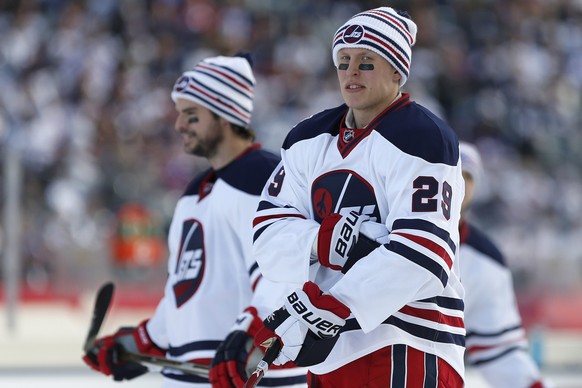 Winnipeg Jets&#039; Drew Stafford (12) and Patrik Laine (29) during the warmup skate at the NHL Heritage Classic in Winnipeg, Manitoba, Sunday, Oct. 23, 2016. (John Woods/The Canadian Press via AP)