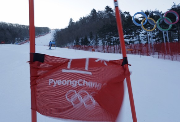 A gate billows in the wind after the women&#039;s giant slalom was postponed due to high winds at the 2018 Winter Olympics at the Yongpyong Alpine Center, Pyeongchang, South Korea, Monday, Feb. 12, 20 ...