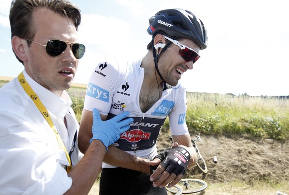 Giant-Alpecin rider Tom Dumoulin of the Netherlands (R) receives assistance after a fall during the 159,5 km (99 miles) third stage of the 102nd Tour de France cycling race from Anvers to Huy, Belgium ...