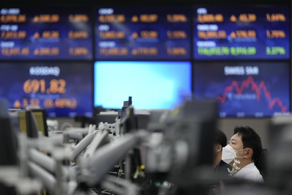 A currency trader watches computer monitors at a foreign exchange dealing room in Seoul, South Korea, Tuesday, Oct. 25, 2022. Shares advanced Tuesday in Asia after Wall Street shook off an early bout  ...
