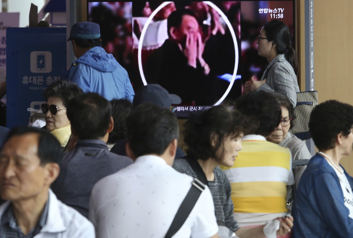 People watch a TV screen showing an image of senior North Korean official Kim Yong Chol in a musical performance by the wives of Korean People's Army officers in North Korea during a news program ...