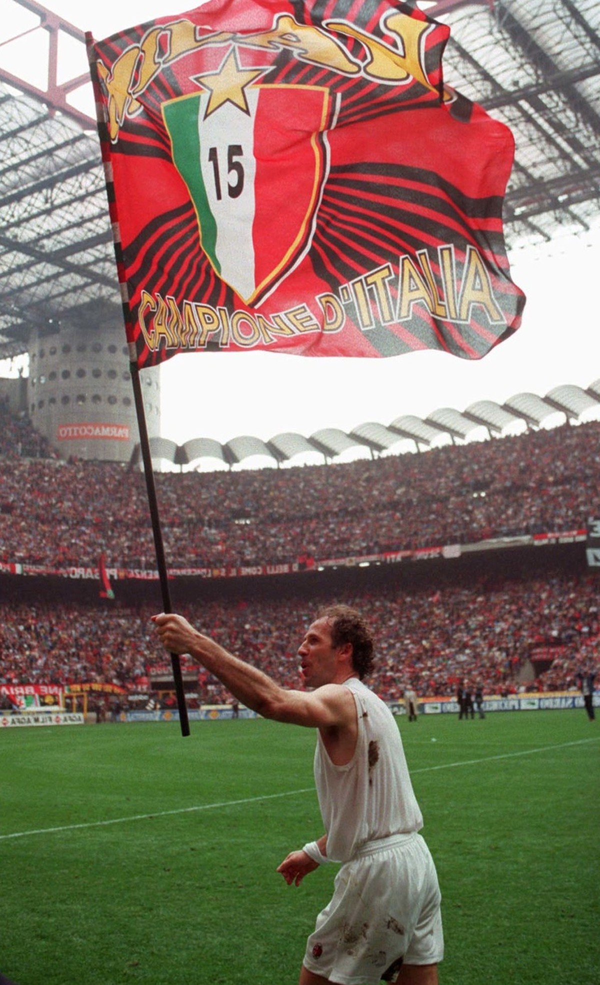 AC Milan's captain Franco Baresi carries a flag with the 15 scudetti (Italian league titles) of AC Milan at Milan's San Siro stadium on Sunday, April 28, 1996. Baresi, who redifined the swee ...