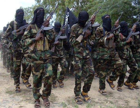 FILE - Al-Shabab fighters conduct military exercise in northern Mogadishu&#039;s Suqaholaha neighborhood, Somalia, Sunday, Sept. 5, 2010. The heads of states of Somalia, Djibouti, Ethiopia and Kenya h ...