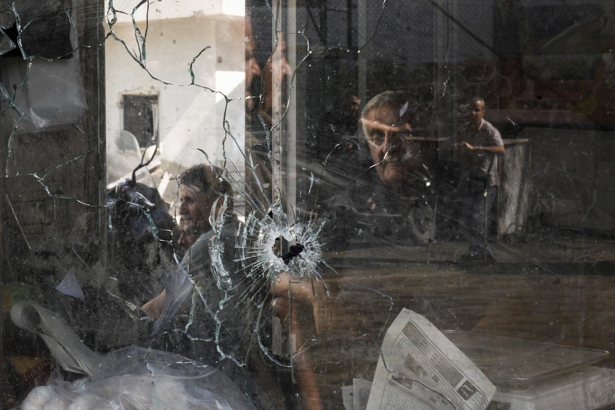 A bullet hole is seen in a shop window following an Israeli military raid in the Jenin refugee camp, West Bank, Wednesday, Sept. 20, 2023. Palestinian health officials say the death toll over a day of ...