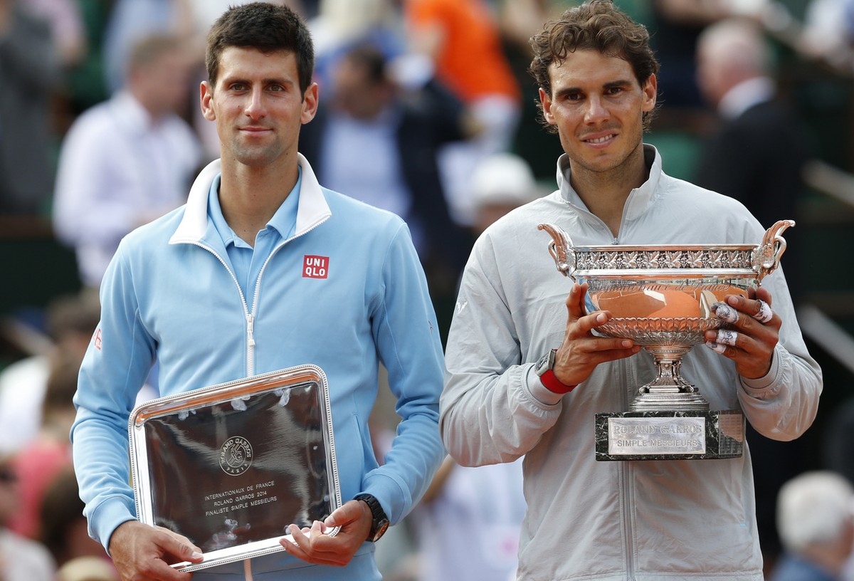 Spain's Rafael Nadal, right, holds the trophy after winning the final of the French Open tennis tournament against Serbia's Novak Djokovic, left, at the Roland Garros stadium, in Paris, Fran ...