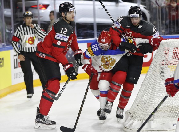 Canada&#039;s Colton Parayko, left, and Marc-Edouard Vlasic, right, tackle Russia&#039;s Nikita Kucherov at the Ice Hockey World Championships semifinal match between Canada and Russia in the LANXESS  ...