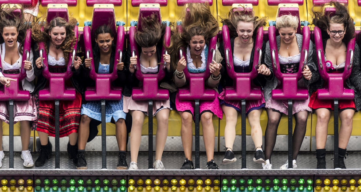 epa06208434 Visitors sit in a leisure ride at the fairground during the opening of the 184rd edition of the annual traditional Oktoberfest beer and amusement festival in the German Bavaria state&#039; ...