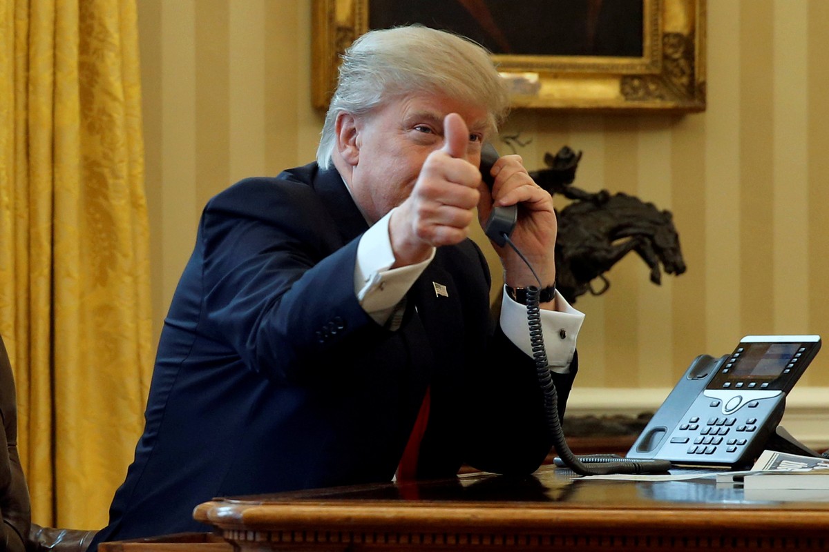 U.S. President Donald Trump gives a thumbs-up to reporters as he waits to speak by phone with Saudi Arabia's King Salman in the Oval Office at the White House in Washington, U.S. January 29, 2017 ...