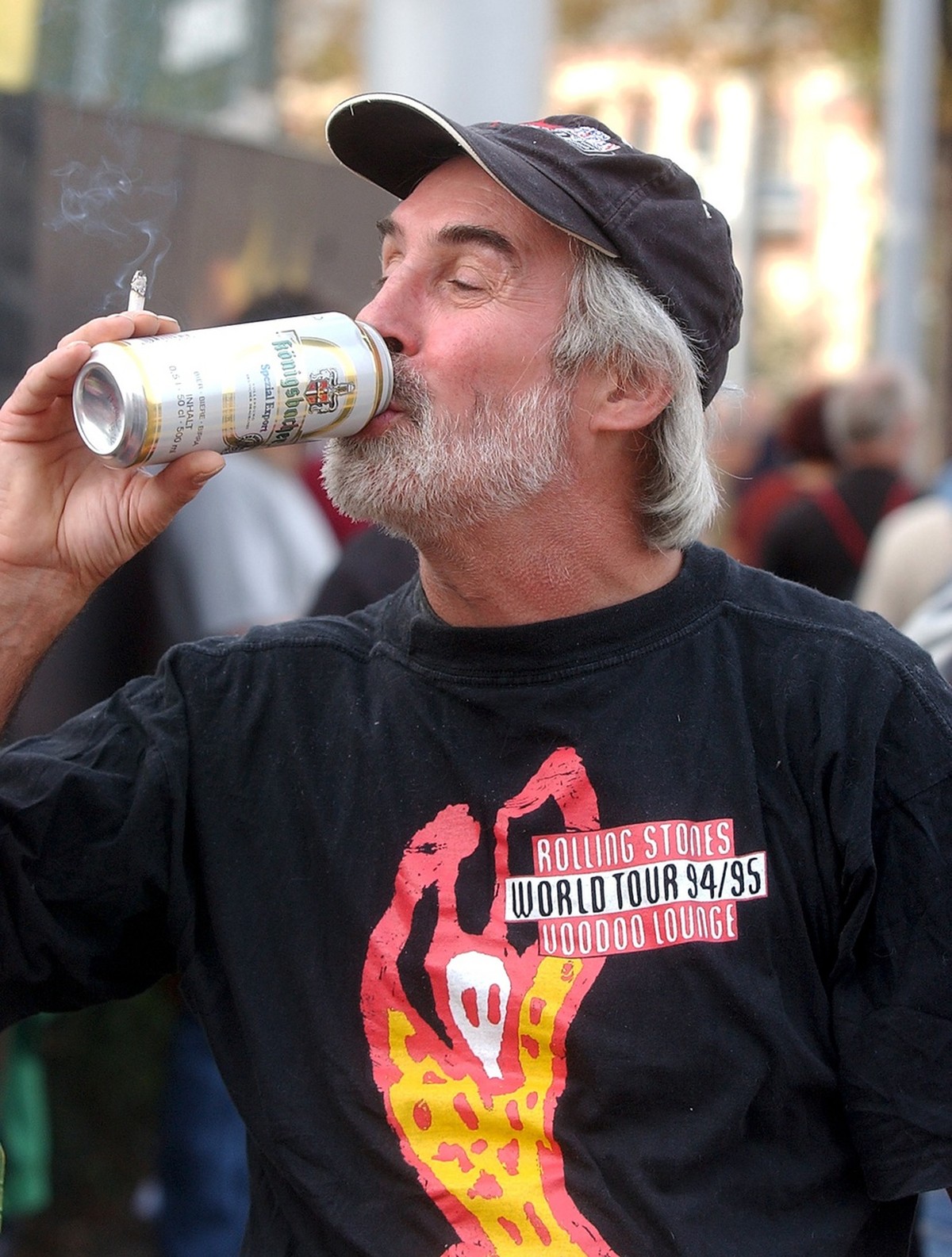 A fan of British rock group "The Rolling Stones" drinks a beer in front of the Letzigrund stadium in Zurich, Switzerland, Thursday, October 2, 2003. The Rolling Stones are performing during  ...