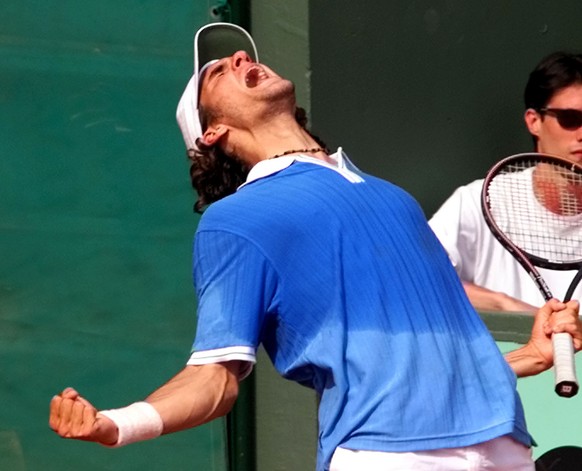 Roger Federer of Switzerland reacts after he defeated his compatriot Michel Kratochvil 7-6, 6-4, 2-6, 6-7, 8-6, during their third round match at the French Open tennis tournament at Roland Garros sta ...