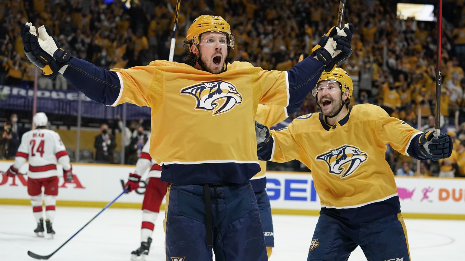 Nashville Predators center Ryan Johansen, left, celebrates with Filip Forsberg, right, after Johansen scored a goal against the Carolina Hurricanes during the second period in Game 4 of an NHL hockey  ...