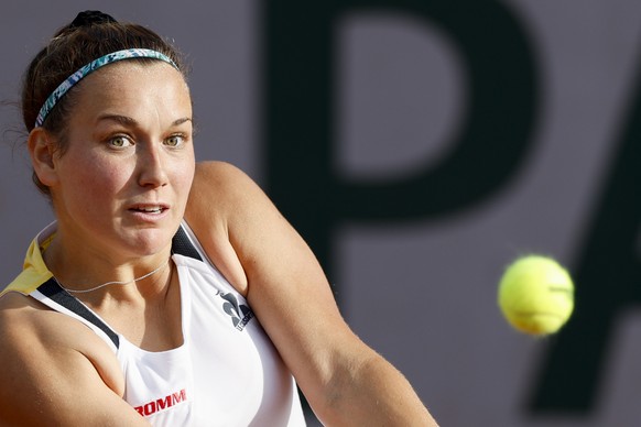 Ylena In-Albon of Switzerland eyes the ball as she plays a shot against Claire Liu of the U.S. during their first round match of the French Open tennis tournament at the Roland Garros stadium in Paris ...