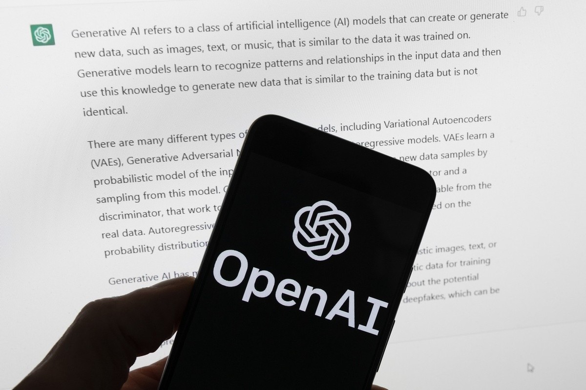 FILE - The OpenAI logo is seen on a mobile phone in front of a computer screen displaying output from ChatGPT, March 21, 2023, in Boston. The U.S. Federal Trade Commission has launched an investigatio ...