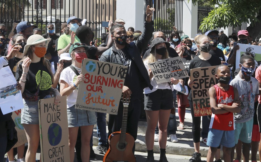 Activists protest for climate justice outside parliament in Cape Town, South Africa, Tuesday, Nov. 9, 2021. The protest coincides with the second week of as the COP26, UN Climate Summit in Glasgow. (A ...