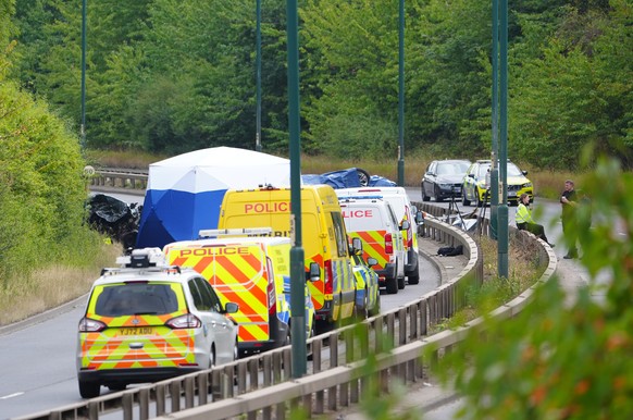 Police officers at the scene of a fatal crash involving a police car and a Volkswagen Passat on the A66 in South Bank, near Middlesbrough, England, Saturday Aug. 22, 2026. (Owen Humphreys/PA via AP)
B ...