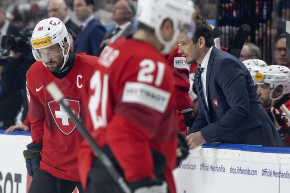 Switzerland&#039;s Headcoach Patrick Fischer, right, and Switzerland&#039;s Roman Josi react during the Ice Hockey World Championship semi final match between Switzerland and Canada in Prague at the O ...