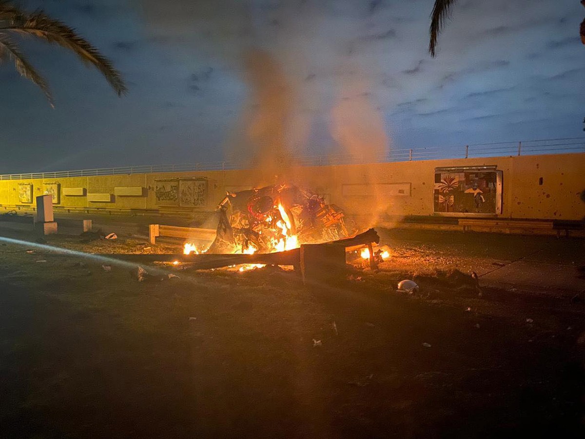 epa08099403 A handout photo made available by Iraq's military-run Security Media Cell via facebook shows a burning vehicle near Baghdad International Airport, Iraq, 03 January 2020. According to  ...
