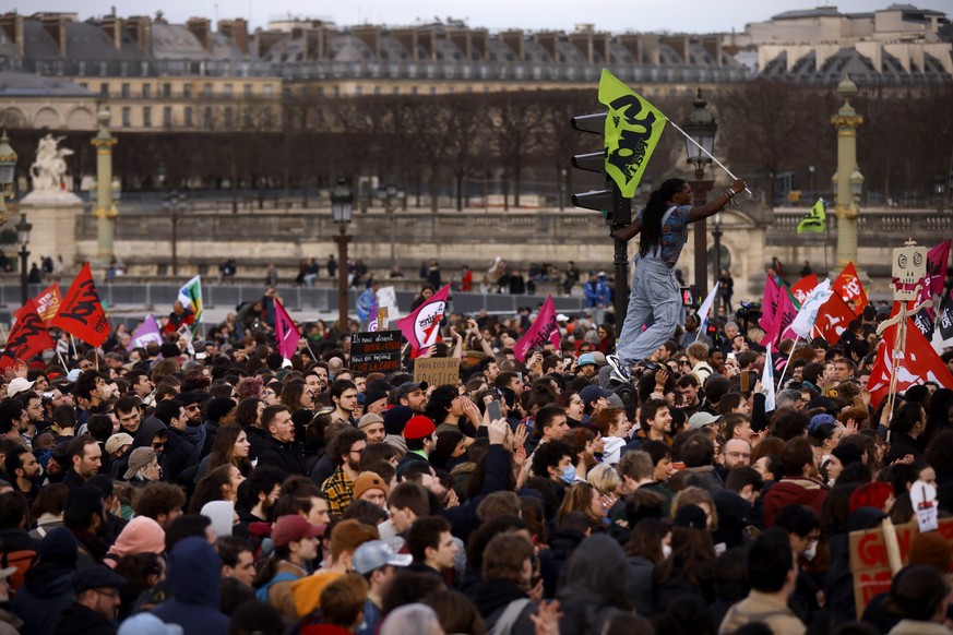 Protesters gather at Concorde square near the National Assembly in Paris, Thursday, March 16, 2023. French President Emmanuel Macron has shunned parliament and opted to push through a highly unpopular ...