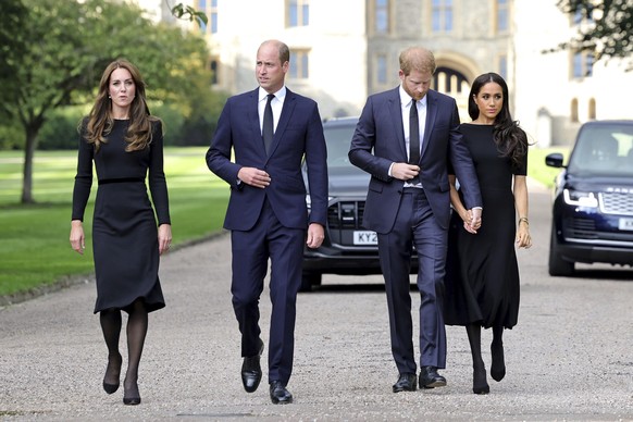From left, Britain's Kate, Princess of Wales, Prince William, Prince of Wales, Prince Harry, and Meghan, Duchess of Sussex walk to meet members of the public, at Windsor Castle, following the dea ...