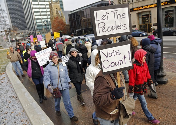 Protesters against Donald Trump march outside the Ohio statehouse before the Electoral College members vote in Columbus, Ohio, Monday, Dec. 19, 2016. All 18 of Ohio&#039;s Electoral College members vo ...